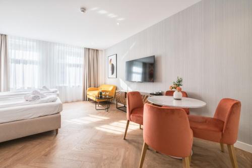a hotel room with a bed and a table and chairs at Retro Boutique by NorthSide Apartments in Gdańsk
