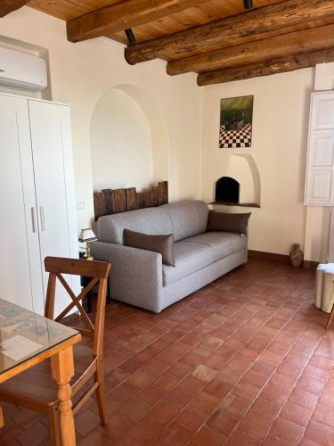 a living room with a couch and a fireplace at Puleera Boutique Hotel in Giarre