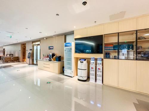 a large kitchen with refrigerators and cabinets in it at Yibo Hotel - Pazhou Convention and Exhibition Center - Walking distance to Canton Fair in Guangzhou