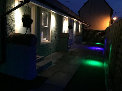 a house with a green light in the dark at Irvine Bay in Irvine