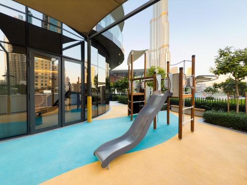 a playground in a building with a slide at Bella Elite Homes at Grande Signature Full Burj and Fountain View Downtown - Brand New Luxury Apartment in Dubai