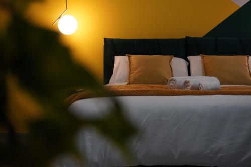 a close up of a bed with pillows at Lux Home & Garden in Lago
