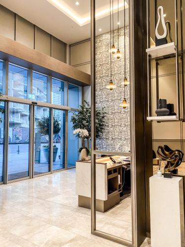 an office lobby with a desk and a brick wall at Bella Elite Homes at Grande Signature Full Burj and Fountain View Downtown - Brand New Luxury Apartment in Dubai