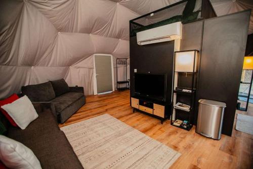 a living room with a couch and a tent at 2 domes in Glendale Utah Fantastic Stargazing in Glendale