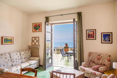 a living room with a view of the ocean at Villa Maria Lake View,7 minuti a piedi dal centro, parcheggio privato in Torri del Benaco