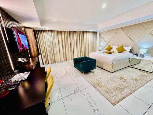 a hotel room with a bed and a television at H & H Boutique & SPA in Roodepoort