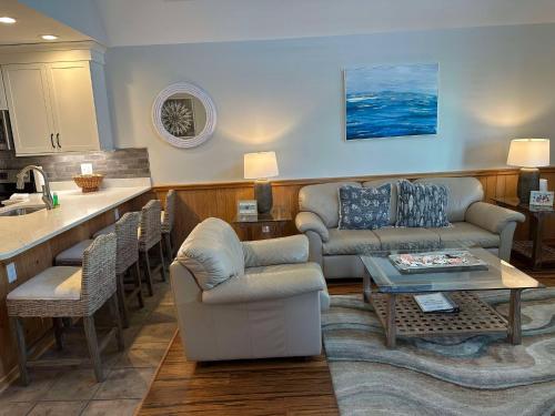 a living room with a couch and a table at Courtyard Villas On Silver Lake in Ocracoke