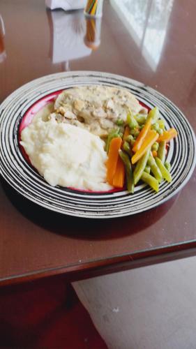 a plate of food with vegetables on a table at Quinta Divina Providencia in Fusagasuga