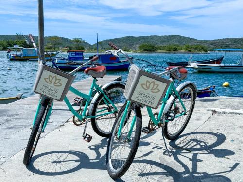 two bikes parked on a dock near the water at Hotel Boutique Recanto da Passagem in Cabo Frio
