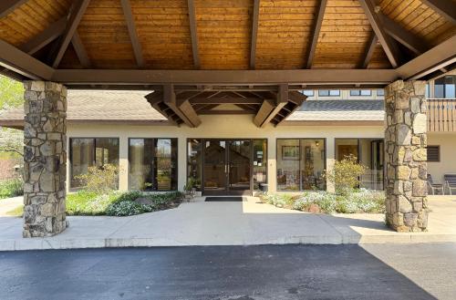 a large building with a wooden ceiling and glass doors at Talley Ho Inn in Townsend