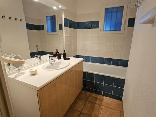 a bathroom with a sink and a tub at Logis de Gaia YourHostHelper in Homps