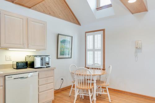 a kitchen with a table and chairs and a microwave at Courtyard Villas On Silver Lake in Ocracoke