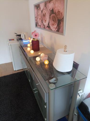 a desk with a lamp and candles on it at Devils Peak Prague in Prague