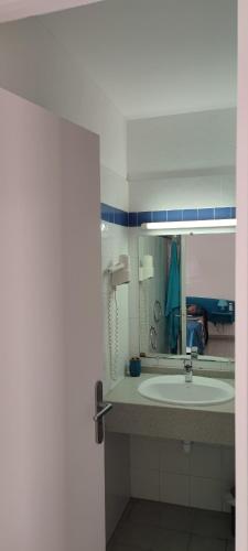 a bathroom with a sink and a mirror at TOUMALACAÏ Appart 245 in Folle Anse