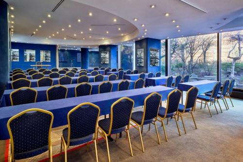 a conference room with blue tables and chairs at The Westin Leipzig in Leipzig