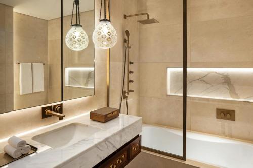 a bathroom with a large tub and a shower at Bab Samhan, a Luxury Collection Hotel, Diriyah in Riyadh