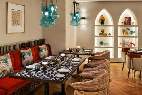 a restaurant with two tables and chairs and blue lights at Bab Samhan, a Luxury Collection Hotel, Diriyah in Riyadh
