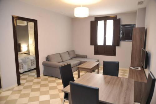 a living room with a couch and a table at ADANAR-Las Columnas in Granada