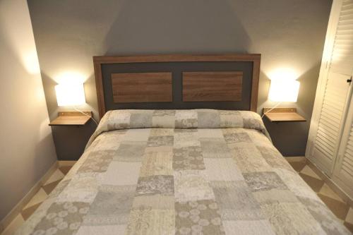 a bedroom with a large bed with two lamps on both sides at ADANAR-Las Columnas in Granada