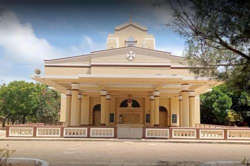 a large white building with a tower on top at Agro Village Resort , Kalpitiya in Kalpitiya