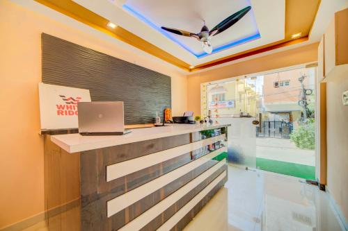 a room with a counter with a laptop on it at Hotel O White Ridge in Hyderabad
