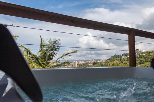 a bath tub with a view of the ocean at Mayka cabañas con JACUZZI in Guatapé