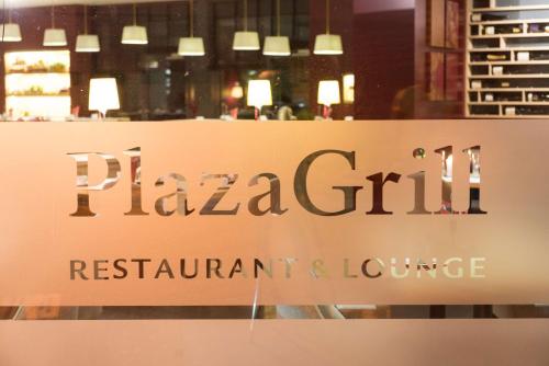 a sign in the window of a restaurant and lounge at Park Plaza Trier in Trier