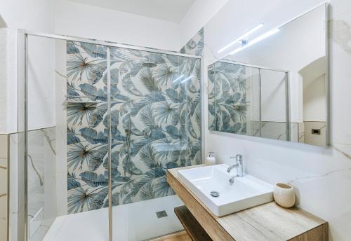a bathroom with a sink and a mirror at Villa Amato Rooms & Apartment in Ischia