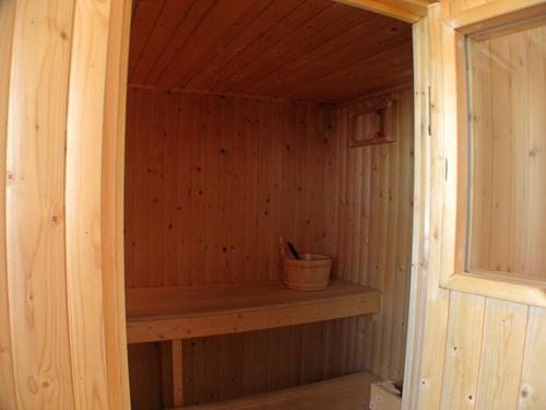 a wooden sauna with a wooden shelf in it at Auchendennan Farm Self Catering Cottages in Balloch