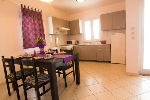a kitchen with a table and chairs in a room at Apartments Dario in Krk