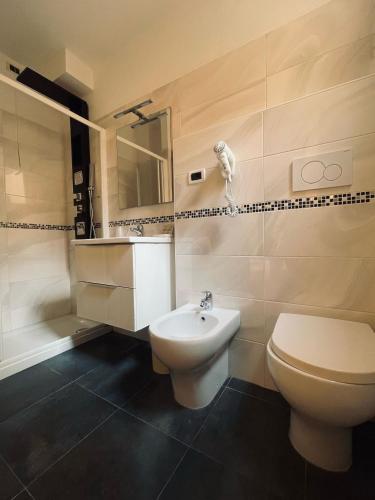 a bathroom with a toilet and a sink at Hotel Holiday- Alla Finestrella in Bologna