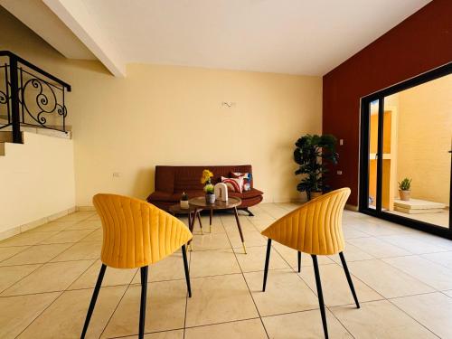 a living room with two chairs and a table at Los Olivos in Esquipulas