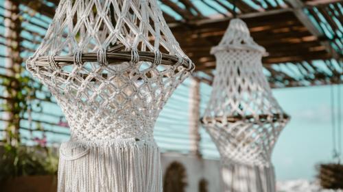 two white nets are hanging from a building at Bagá 201 By Rotamundos in Playa del Carmen