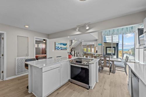 a kitchen with white appliances and a dining room at N3709- Game Changer in Nags Head