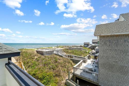 a view of the ocean from the balcony of a house at N3709- Game Changer in Nags Head