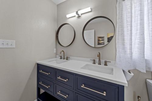 a bathroom with a sink and a mirror at N3709- Game Changer in Nags Head