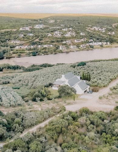 an aerial view of a house next to a river at Oudewerfskloof Olive Farm in Stilbaai