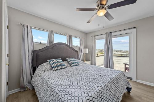 a bedroom with a bed and a ceiling fan at N3709- Game Changer in Nags Head