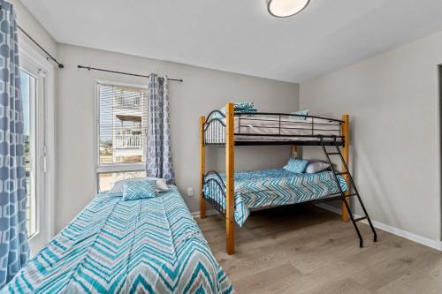 a bedroom with a bunk bed and a bed at N3709- Game Changer in Nags Head