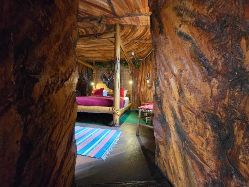 a room with a bed in a log cabin at Norrqvarn Hotel & Resort by Vänerport in Lyrestad