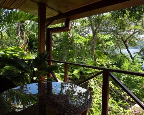 a balcony with a table and a view of the forest at Casa Marimba in La Laguna