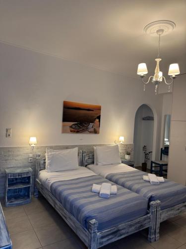 a bedroom with two beds with towels on them at Phoenix in Fira