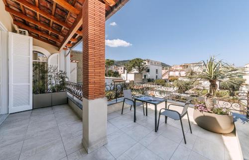 a patio with a table and chairs on a balcony at Villa Amato Rooms & Apartment in Ischia
