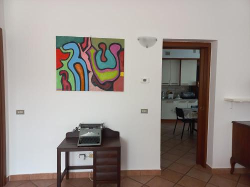 a living room with a table and a painting on the wall at La testuggine in Giussano
