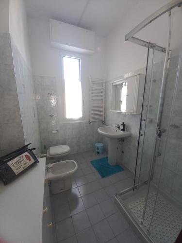 a bathroom with a toilet and a sink and a shower at La testuggine in Giussano