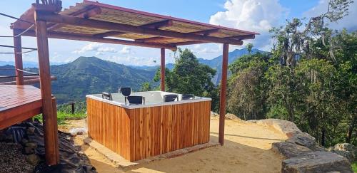 a hot tub sitting on top of a mountain at El Mundo al Revés in Pacho