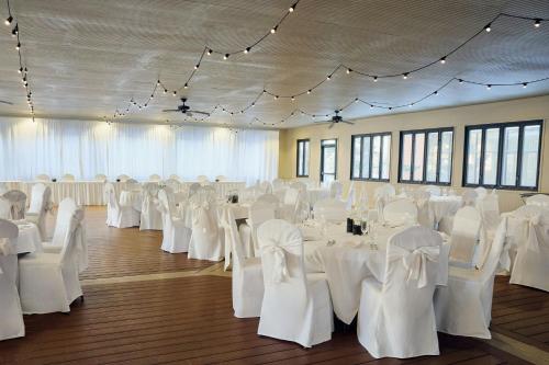 a banquet hall with white tables and chairs at Fort Collins Marriott in Fort Collins