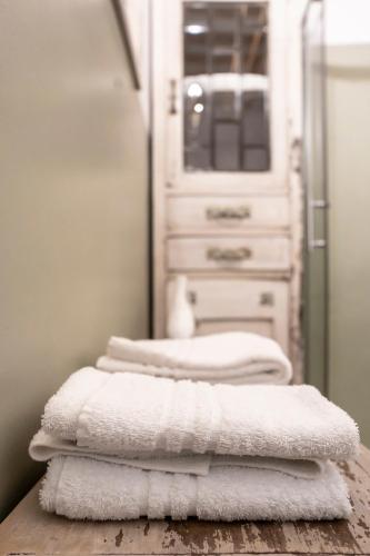 a pile of towels sitting on a table in a bathroom at Le Terrazze Del Chianti b&b Residenza d'Epoca e di Charme in Tavarnelle in Val di Pesa