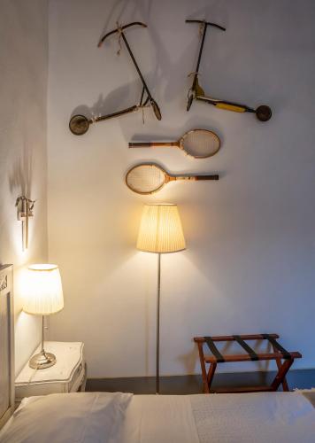 a bedroom with tennis rackets hanging on the wall at Le Terrazze Del Chianti b&b Residenza d'Epoca e di Charme in Tavarnelle in Val di Pesa