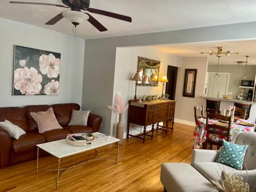 a living room with a couch and a table at Come home to Kenwood Conveniently located Syracuse in Syracuse